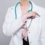 Doctor Putting Bribe into Pocket