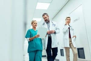 Doctors team walking in hospital corridor