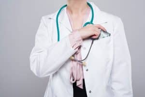 Doctor Putting Bribe into Pocket