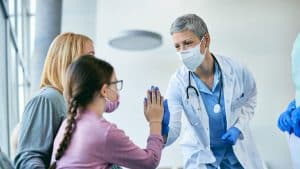 Doctor giving high-five to a girl